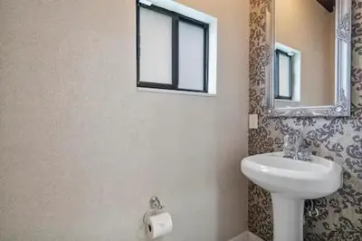 a bathroom with a sink and a mirror at New Townhome near Wilton/Las Olas/Beach in Fort Lauderdale