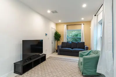 a living room with a couch and a fireplace at Beautiful, fully furnished 2bed 1bath house - 5 minute walk to Miracle Mile Downtown Coral Gables in Miami