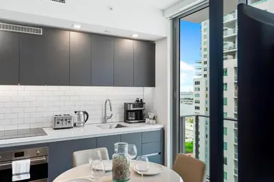 a kitchen with a table and chairs and a window at - Casiola Studio's - near Cruise Terminal, Bayfront Park and Kaseya Center in Miami