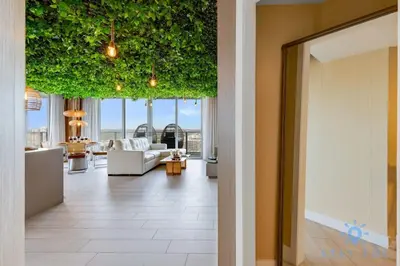 a hallway with a living room with plants on the ceilings at Jungle Experience, High Floor, Pools in Hollywood