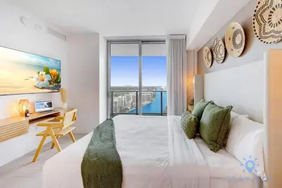a bedroom with a bed and a desk with a window at Jungle Experience, High Floor, Pools in Hollywood