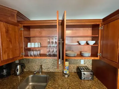 a kitchen with a sink and a counter with dishes at Ocean reserve 702 - STR 2315 in Miami Beach