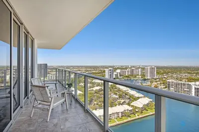 a balcony with two chairs and a view of the water at HighFloor with Stunning Views, Pools, Near Beach in Hollywood