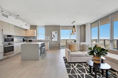a kitchen and living room with a couch and a table at HighFloor with Stunning Views, Pools, Near Beach in Hollywood
