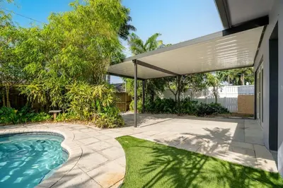 a swimming pool in a backyard with a pavilion at Hollys Hacienda with Heated Pool and Patio Area in Hollywood