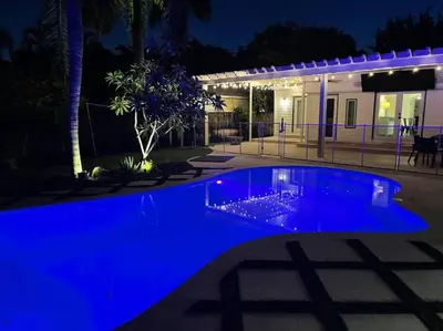 a blue swimming pool at night at Victoria Park Oasis with Heated Pool and More in Fort Lauderdale