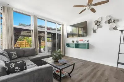 a living room with a couch and a ceiling fan at Wileys Paradise Three Bedroom Two Bath plus Office and Heated Pool in Hollywood