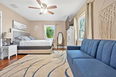 a bedroom with a blue couch and a bed at Wileys Paradise Three Bedroom Two Bath plus Office and Heated Pool in Hollywood