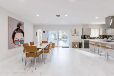 a kitchen and dining room with a table and chairs at Olas Villa by Rove Travel - Home with Heated Pool in Fort Lauderdale