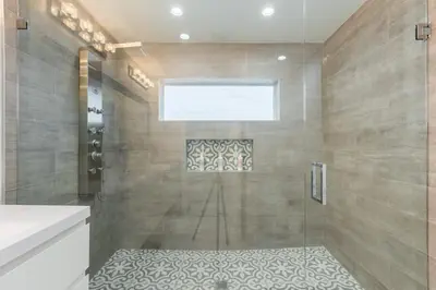 a bathroom with a shower with a glass door at Olas Villa by Rove Travel - Home with Heated Pool in Fort Lauderdale