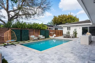 a swimming pool in the backyard of a house at Olas Villa by Rove Travel - Home with Heated Pool in Fort Lauderdale