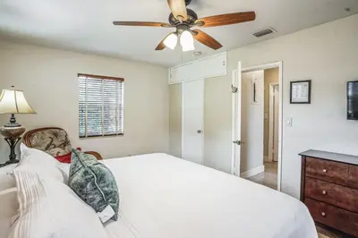 a bedroom with a bed with a ceiling fan at Beautiful Comfy Home With Private Hot Tub Close To Beach home in Fort Lauderdale