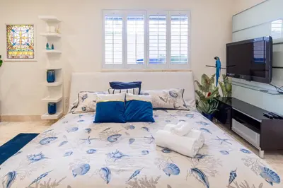 a bedroom with a bed with a blue and white comforter at Oceana Blue / Beach Front / Pool / Bar / Relax in Fort Lauderdale