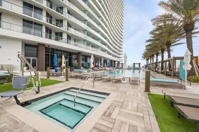 a pool at a hotel with palm trees and a building at Ocean Front Paradiiise 3 Bedroom by Zen in Hollywood