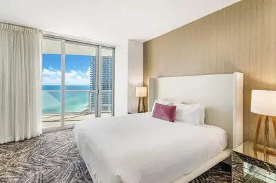 a bedroom with a large bed and a large window at Ocean Front Paradiiise 3 Bedroom by Zen in Hollywood