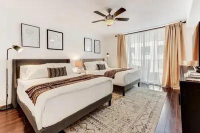 a bedroom with two beds and a ceiling fan at Elegant 1BR APT w balcony and stunning bay view in Miami