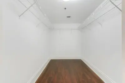 an empty room with white walls and a wooden floor at Elegant 1BR APT w balcony and stunning bay view in Miami