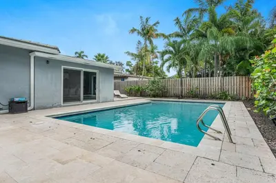 a swimming pool in the backyard of a house at Modern 4BR Villa with Pool - Outdoor amenities - WFH in Fort Lauderdale