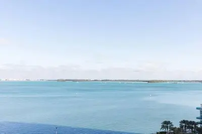 a view of a large body of water with palm trees at Penthouse APT w Private Balcony King Bed Parking in Miami
