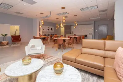 a living room with a couch and tables and chairs at Ocean view Work from Home Balcony Parking Pool in Miami