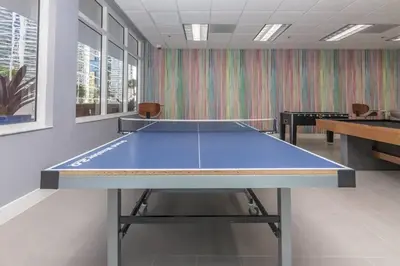 a large blue ping pong table in a room at Ocean view Work from Home Balcony Parking Pool in Miami