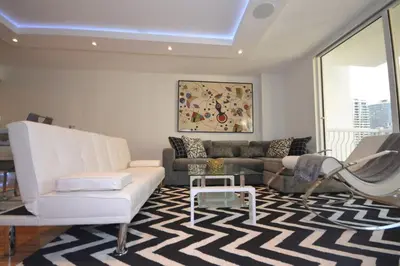 a living room with a couch and a table at LUXURY CONDO LOCATED iN THE HEART OF MIAMI in Miami