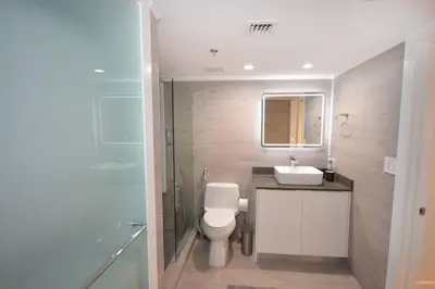 a bathroom with a toilet and a sink and a shower at LUXURY CONDO LOCATED iN THE HEART OF MIAMI in Miami