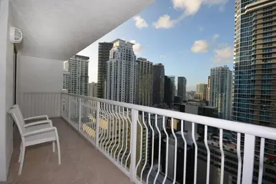 a balcony with a chair and a view of a city at LUXURY CONDO LOCATED iN THE HEART OF MIAMI in Miami