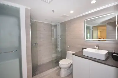 a bathroom with a sink and a toilet and a mirror at LUXURY CONDO LOCATED iN THE HEART OF MIAMI in Miami