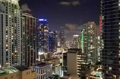 a city skyline at night with tall buildings at LUXURY CONDO LOCATED iN THE HEART OF MIAMI in Miami