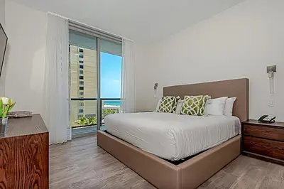 a bedroom with a large bed and a large window at Rooftop Pool - Ocean View Balcony - Hollywood Beach in Hollywood