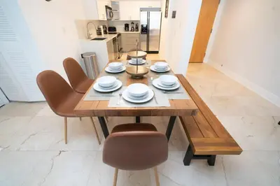 a dining room table and chairs in a kitchen at 2Bed 2 Bath Airbnb Friendly building with Pool, Hot Tub, and Gym in Miami