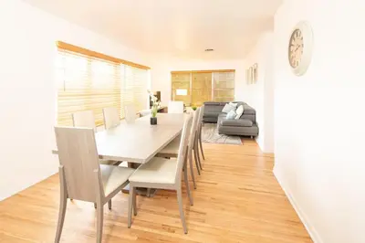 a dining room and living room with a table and chairs at Modern 5 Bedroom Miami Home 15 Min to the Beach in Miami