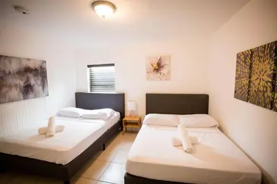 two twin beds in a room with at 3 Bedroom Miami Home 15 Minutes to the Beach in Miami