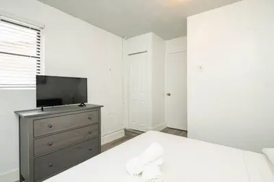 a bedroom with a bed and a tv on a dresser at Waterfront 2-Story Villa with Heated Pool in Pembroke Pines