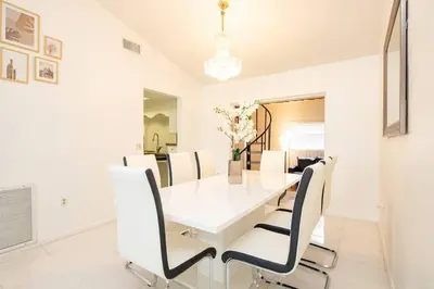 a white dining room with a white table and chairs at Waterfront 2-Story Villa with Heated Pool in Pembroke Pines