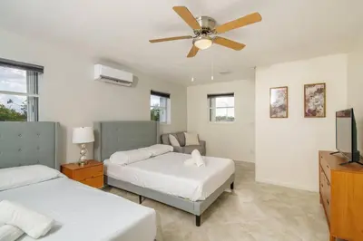 a bedroom with two beds and a ceiling fan at Beautiful 7-Bedroom Villa with Pool in Hialeah
