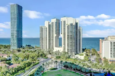a view of a city with tall buildings and the ocean at Lux 2BR Condo in Ocean Reserve with Pools and Tennis Courts in Miami Beach