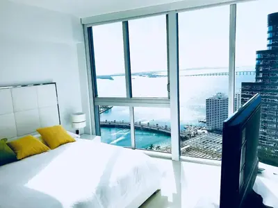 a bedroom with a bed and a large window at Amazing unit Miami Brickell with Sea & City View in Miami