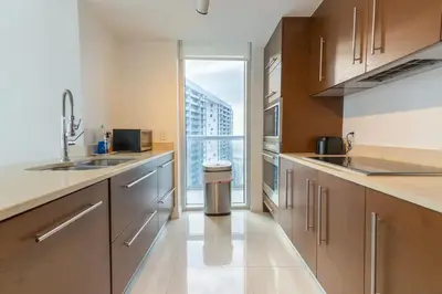a kitchen with stainless steel appliances and a large window at Amazing unit Miami Brickell with Sea & City View in Miami