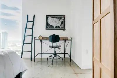 a desk with a ladder and a chair in a bedroom at Sun-Splashed 1BR Condo unit in DWTN Miami with WFH in Miami