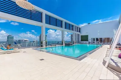 a swimming pool on the roof of a building at Sun-Splashed 1BR Condo unit in DWTN Miami with WFH in Miami