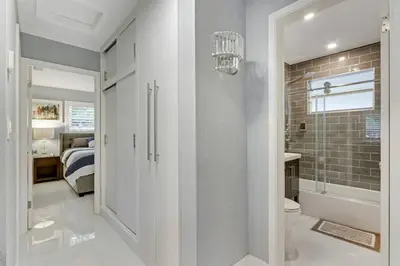 a bathroom with a shower and a toilet and a bedroom at Modern 2BRHouse in Wilton Manors with a Heated Pool and KING Bed in Fort Lauderdale