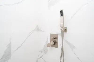a shower in a bathroom with white walls at LuxBright 1BR Brickell Paradise with Oceanview and Parking in Miami