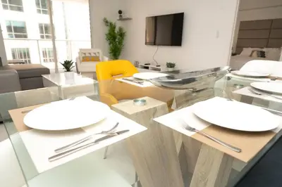 a dining room with white plates on a glass table at LuxBright 1BR Brickell Paradise with Oceanview and Parking in Miami