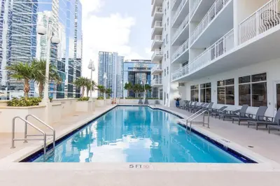 a swimming pool in the middle of a building at LuxBright 1BR Brickell Paradise with Oceanview and Parking in Miami