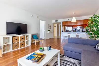 a living room with a blue couch and a table at Ocean and City Views Lux Miami Brickell Sleeps 5 in Miami