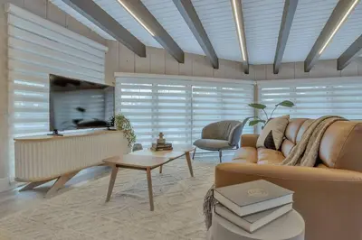 a living room with a couch and a tv at Stunning 2 Story Villa with Pool in Fort Lauderdale