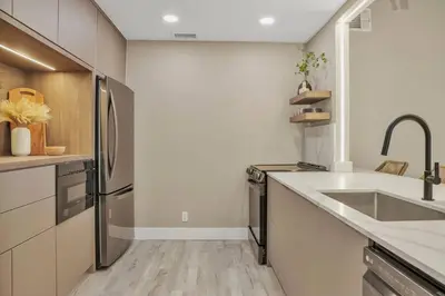 a kitchen with a sink and a refrigerator at Stunning 2 Story Villa with Pool in Fort Lauderdale