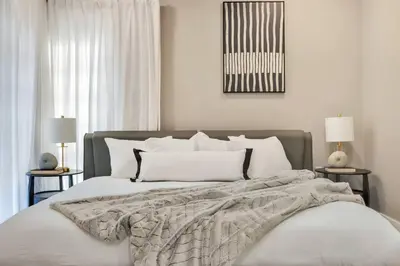 a bedroom with a bed with a blanket and two lamps at Stunning 2 Story Villa with Pool in Fort Lauderdale